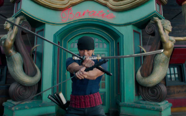 HD wallpaper featuring a Roronoa Zoro live-action portrayal, posed with swords in front of a colorful building with the text 'Baratie'.