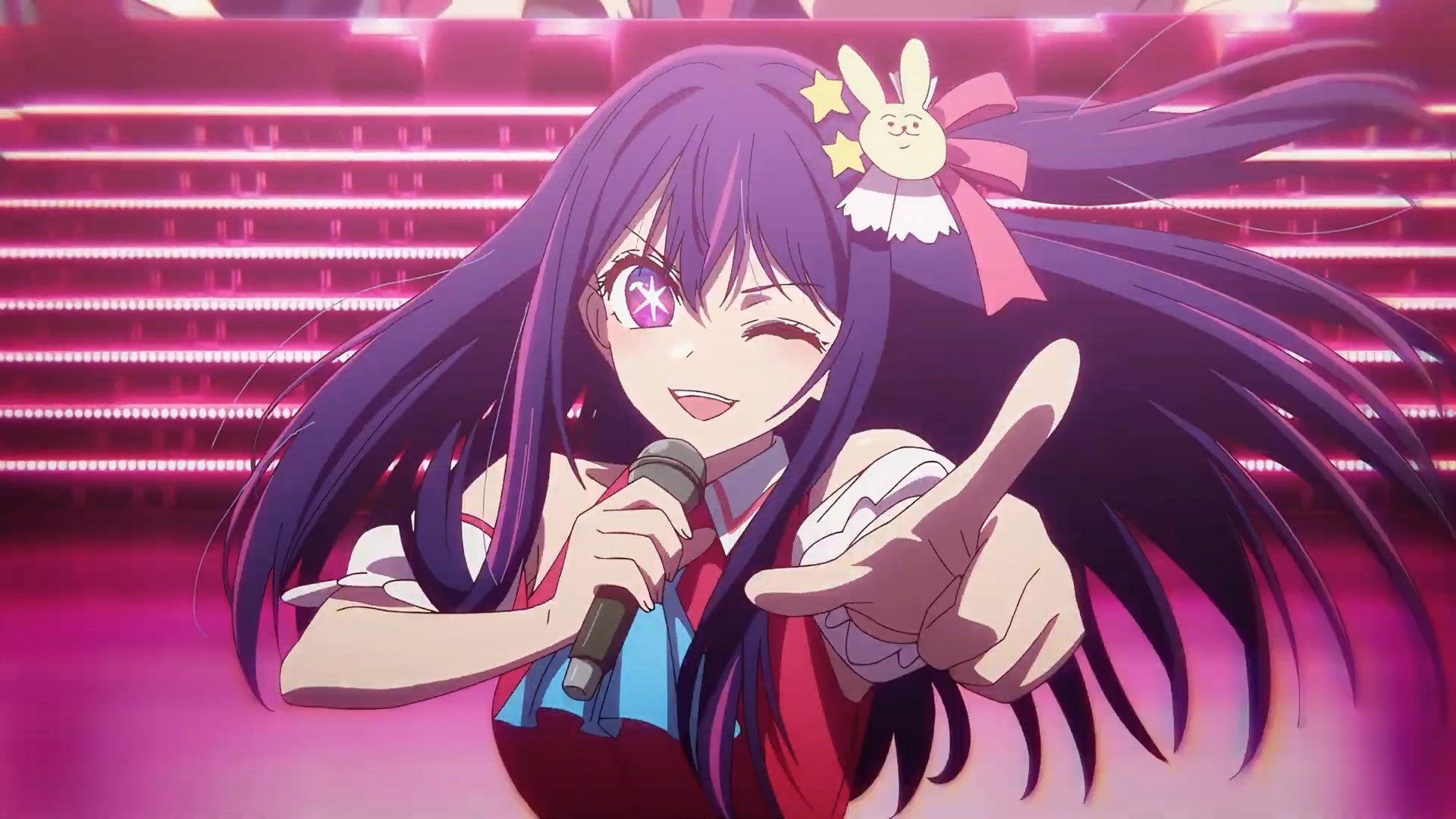 HD PC desktop wallpaper featuring a vibrant anime character from Oshi no Ko, winking and holding a microphone on a neon-lit stage background.