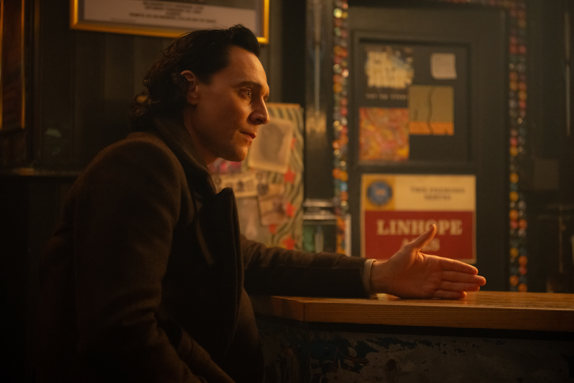 HD desktop wallpaper featuring a contemplative character in a dimly lit setting, evoking the essence of Loki from Marvel Comics.