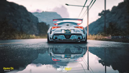 HD desktop wallpaper featuring a sports car from The Crew Motorfest video game, reflecting on wet asphalt with scenic mountain road background.