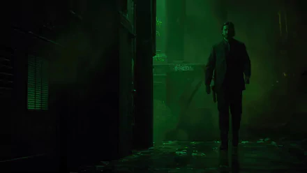 A dark, atmospheric HD wallpaper from Alan Wake 2, featuring a lone figure walking through a shadowy, green-lit environment, evoking suspense and mystery.