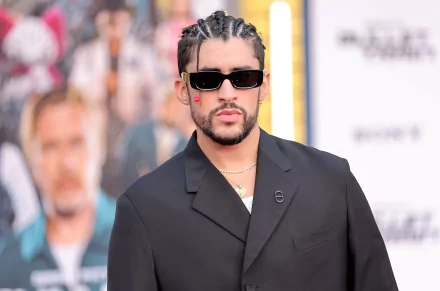 Alt Text: Stylish man in a black suit and sunglasses posing for an HD desktop wallpaper and background.