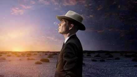 Alt Text: HD wallpaper featuring a man gazing towards the sunset in a desert landscape, reflecting a mix of contemplation and determination.