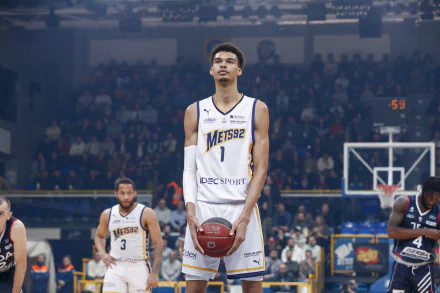 Professional basketball player standing on the court during a game in HD desktop wallpaper.