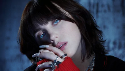 HD desktop wallpaper featuring an artistic portrayal of a popular female musician with blue-toned lighting and a thoughtful expression, wearing a red garment and silver accessories.