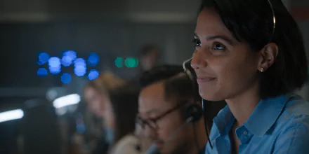 HD desktop wallpaper featuring a focused mission control operator from the TV series For All Mankind, set against a background of computer monitors with ambient blue lighting.