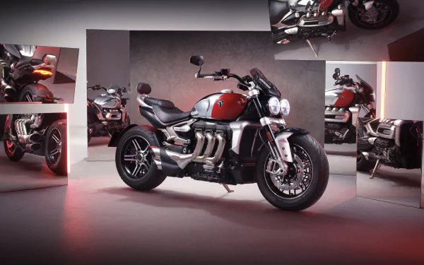 Triumph Rocket III Chrome Edition motorcycle showcased in an HD desktop wallpaper, with multiple views of the powerful Triumph Rocket III GT variant highlighted in the background.