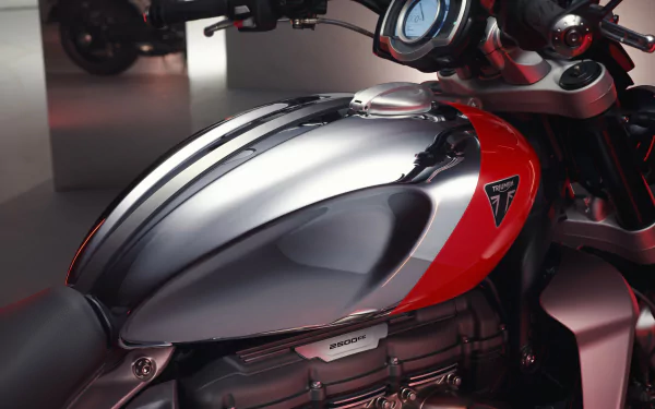 Close-up of the Triumph Rocket III GT in the Triumph Chrome Edition, showcasing its sleek design and powerful engine. An HD desktop wallpaper capturing the essence of luxury and performance.