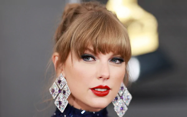HD wallpaper featuring Taylor Swift, showcasing her striking look with elegant earrings and bold makeup, embodying her musical spirit and style.