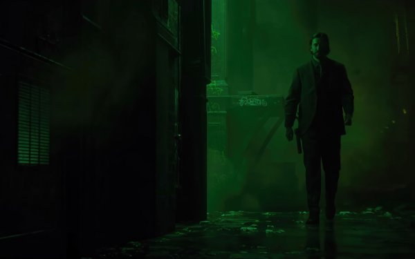 HD desktop wallpaper of Alan Wake 2 showcasing the game's protagonist walking through a dark, eerie alley illuminated by a mysterious green light, perfect for fans and gamers.