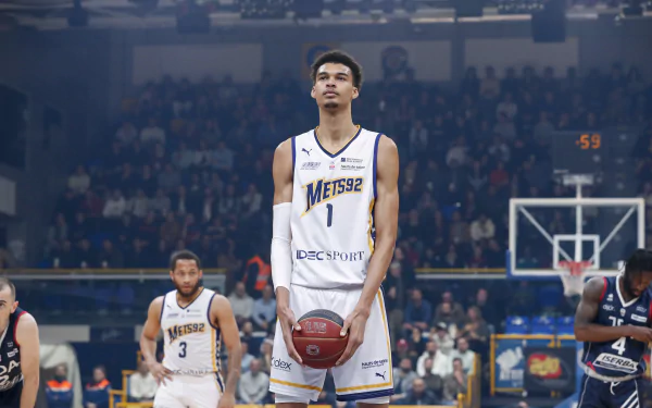 Professional basketball player standing on the court during a game in HD desktop wallpaper.