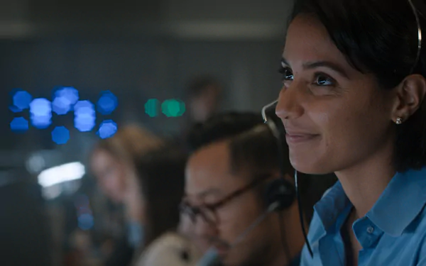 HD desktop wallpaper featuring a focused mission control operator from the TV series For All Mankind, set against a background of computer monitors with ambient blue lighting.