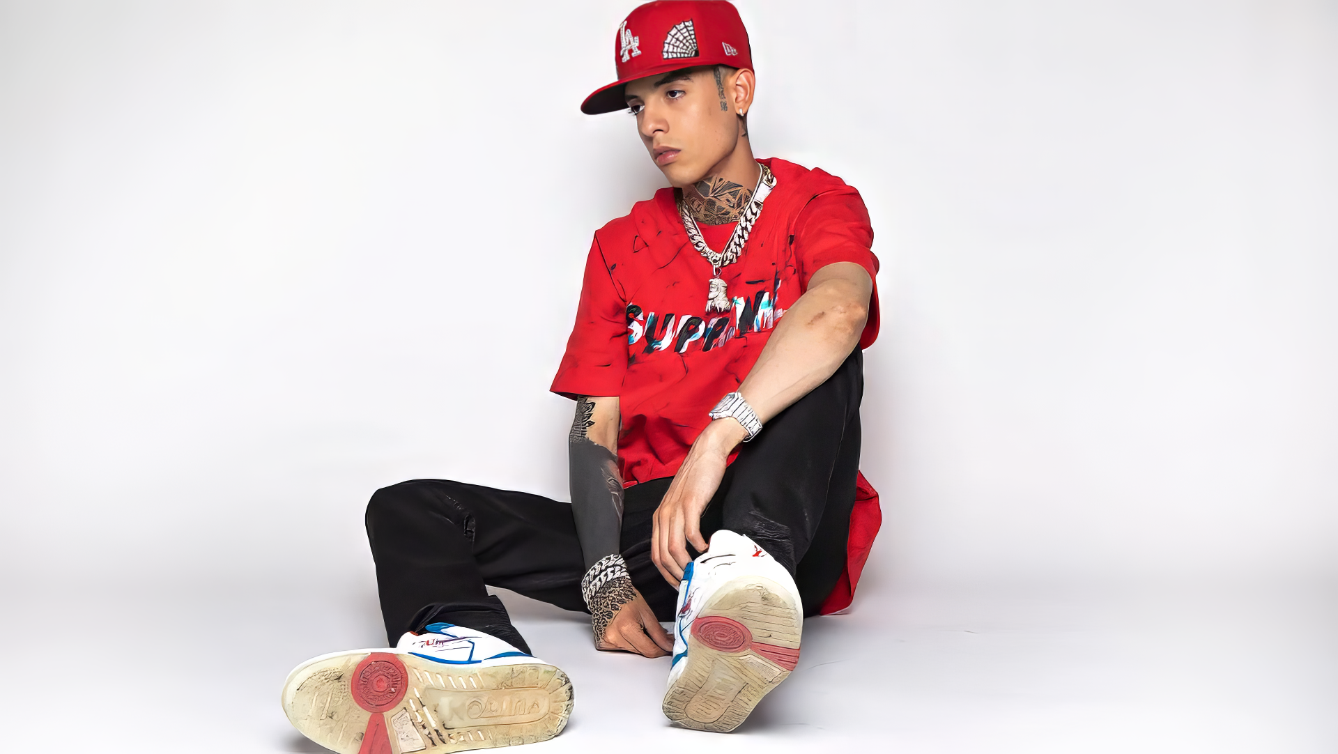 HD desktop wallpaper featuring a person posing confidently in stylish attire with prominent footwear.