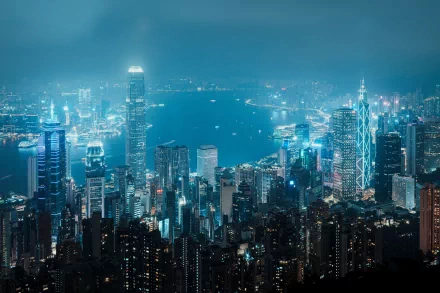 A stunning 8K Ultra HD view of Hong Kong’s cityscape and skyline at night, showcasing vibrant lights and intricate man-made structures along the waterfront.