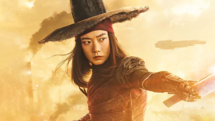 HD desktop wallpaper featuring a character from Rebel Moon movie against a dynamic golden background.