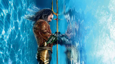 Aquaman character poised with trident in front of a dynamic water backdrop, from Aquaman and The Lost Kingdom movie, in HD wallpaper for desktop backgrounds.