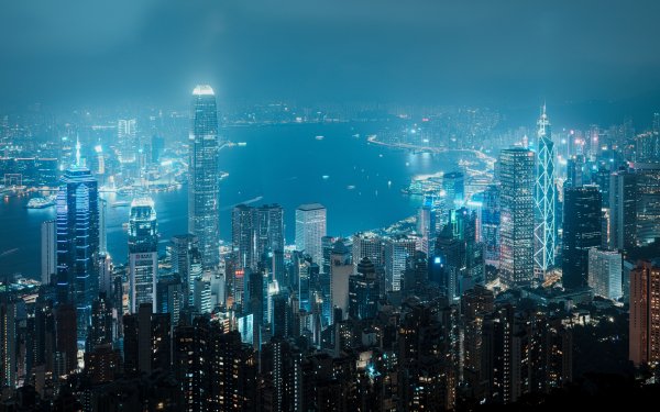 High-definition Hong Kong cityscape wallpaper showcasing a vibrant skyline at night with illuminated skyscrapers, suitable for desktop backgrounds.