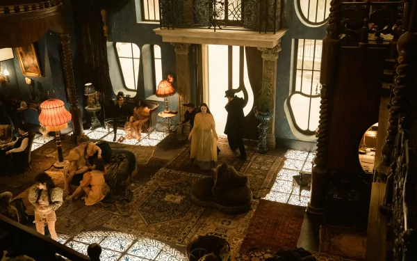 HD desktop wallpaper featuring a scene from the movie Poor Things with characters in a Victorian-style parlor illuminated by warm lighting.