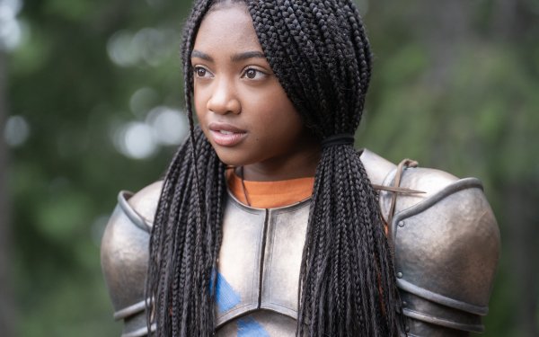 HD wallpaper of a character from the TV show Percy Jackson and the Olympians featuring a young female in armor with braided hair, set against a blurred natural background.
