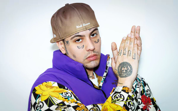 HD desktop wallpaper featuring a person with tattoos posing in a colorful outfit against a white background tagged with Duki.