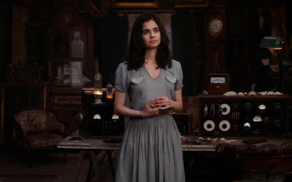 HD wallpaper featuring a scene from the TV show All the Light We Cannot See with a female character standing in a vintage room surrounded by antique radio equipment.