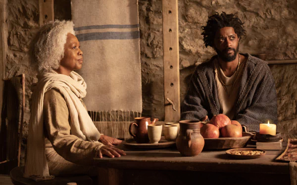 The Book of Clarence movie still featuring two characters in a candlelit scene – HD desktop wallpaper and background.