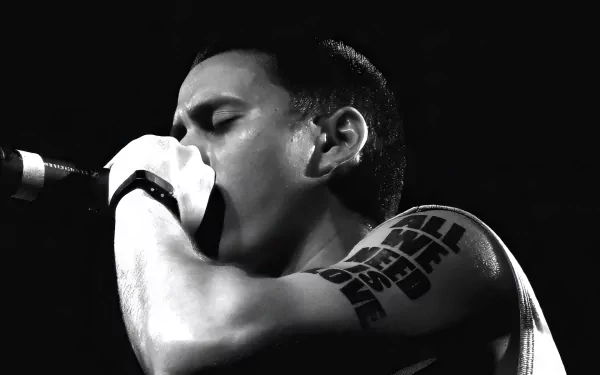 Black and white HD desktop wallpaper background featuring a passionate musician singing into a microphone, symbolizing musical intensity and artistry, related to Canserbero.