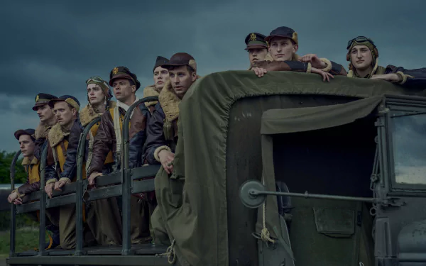 Group of actors portraying soldiers from 'Masters of the Air' TV show, standing in a military vehicle, featured in an HD desktop wallpaper.