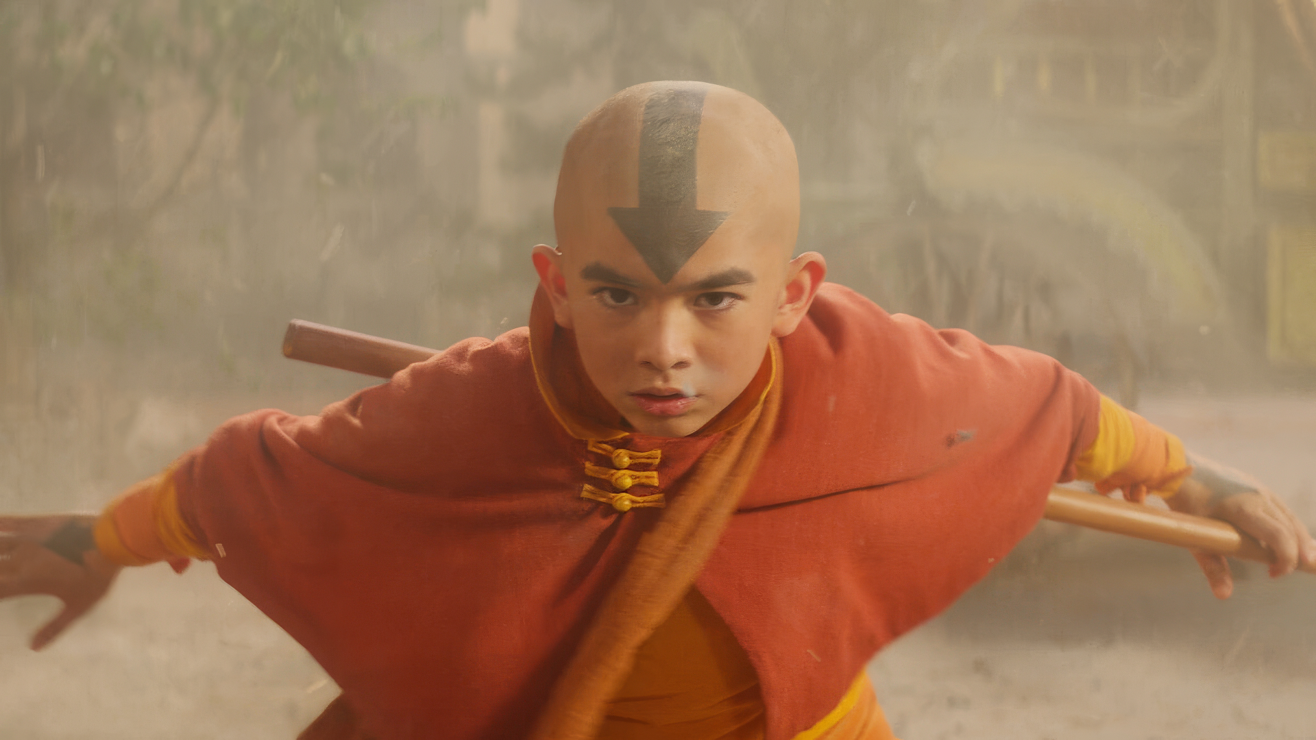 HD wallpaper of Aang from Avatar: The Last Airbender, poised for battle amidst swirling dust.