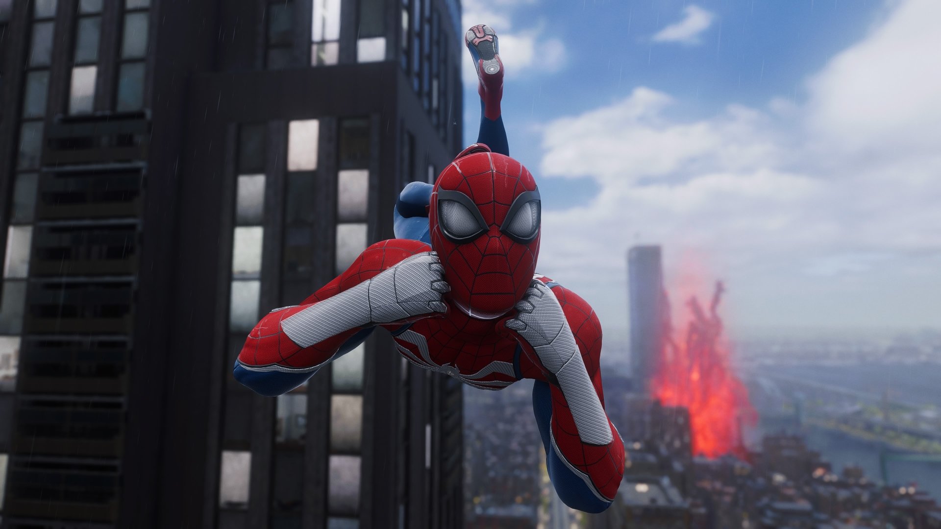 Spider-Man in a red-and-white suit diving toward the camera above a city skyline with a distant fiery explosion — 4K Ultra HD PC desktop wallpaper from Marvel's Spider-Man 2 video game.