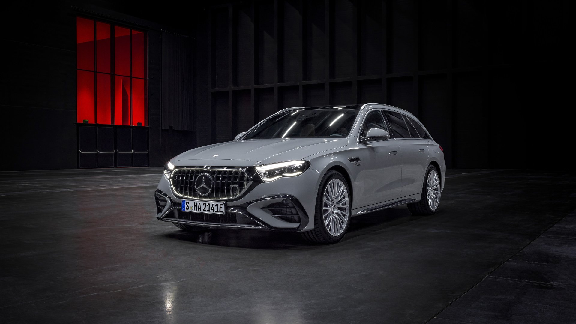 Mercedes-AMG E53 Hybrid car displayed as a HD desktop wallpaper in a dark showroom setting.