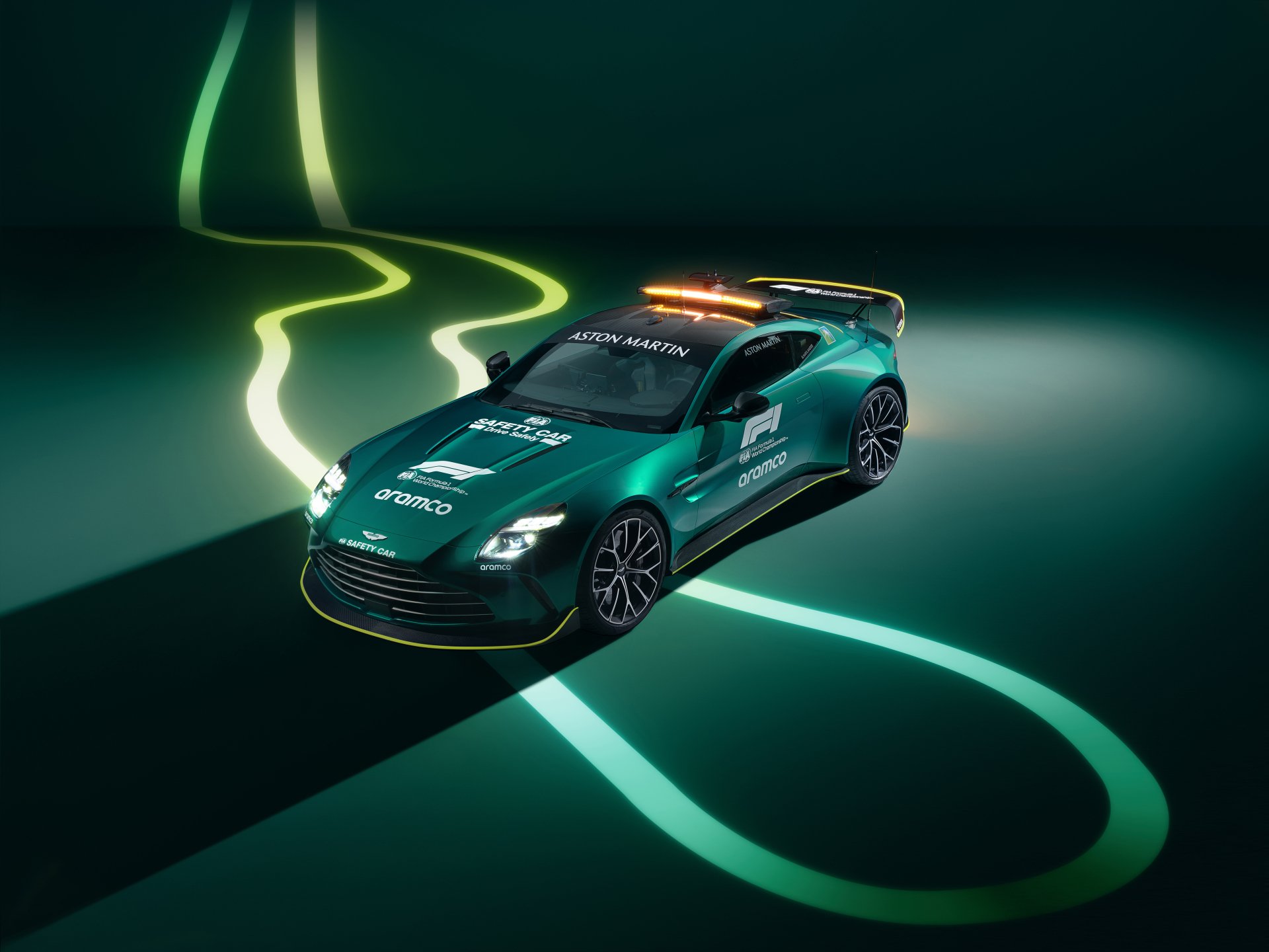 Aston Martin Vantage F1 Edition car showcased in a high-definition desktop wallpaper with dynamic neon light trails as a background.