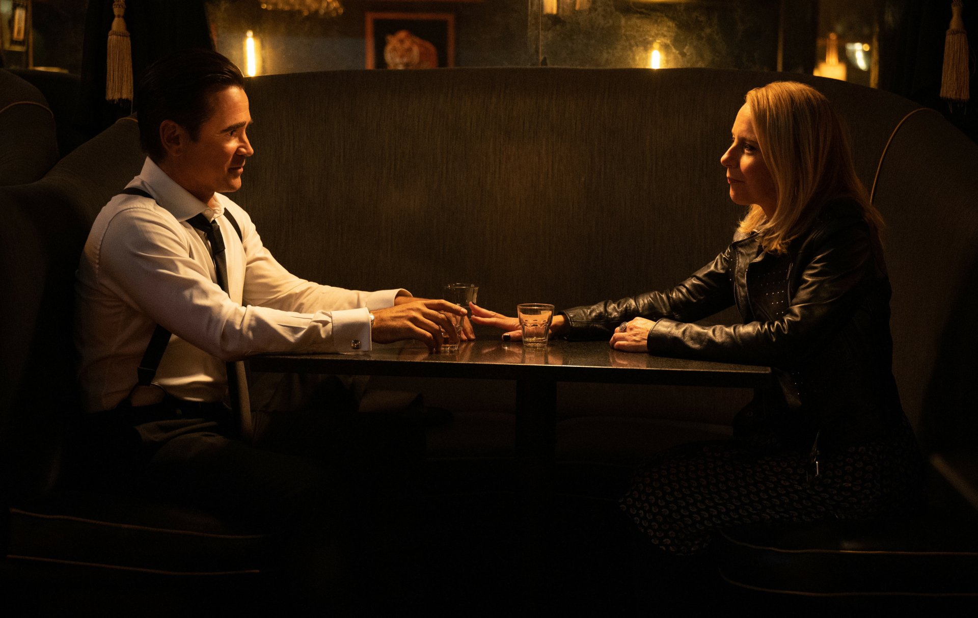 HD wallpaper featuring a scene from the 2024 TV show Sugar with two characters engaging in an intimate conversation at a dimly lit table.