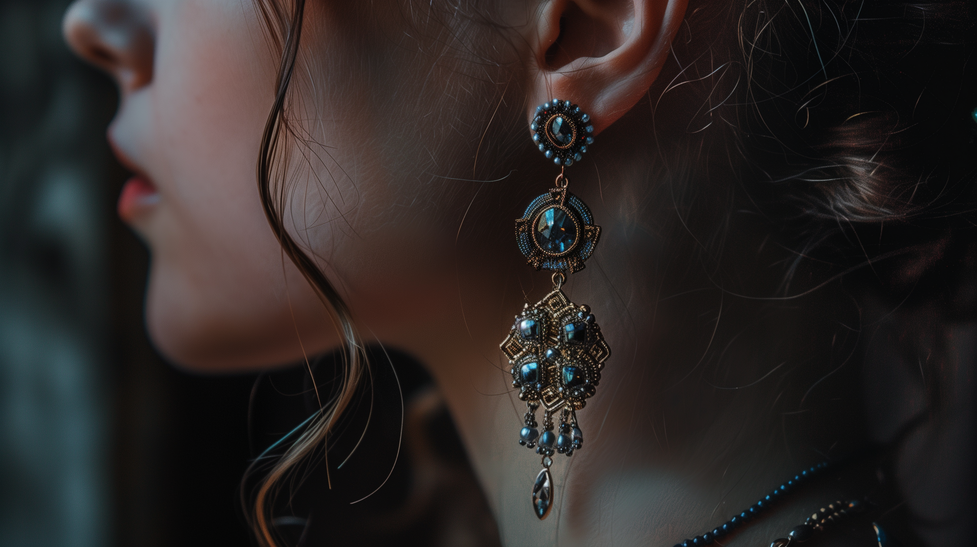 Close-up of a woman wearing intricate earrings as a HD desktop wallpaper.