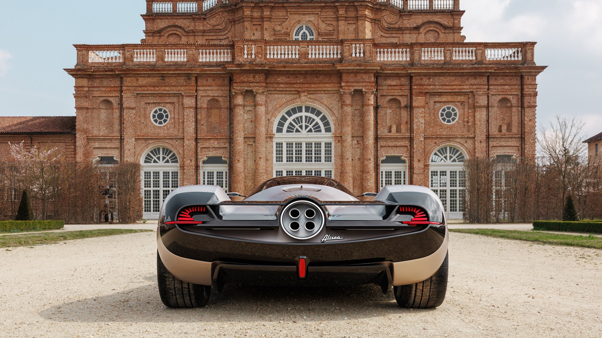 A Pagani Huayra parked in front of an elegant historic building, serving as an HD desktop wallpaper.