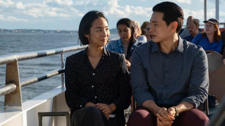 HD desktop wallpaper of two people from the movie Past Lives sitting together on a boat, with water and sky in the background.