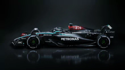 Side view of the Mercedes-AMG Petronas F1 W15 racing car in 4K Ultra HD, showcasing its sleek design and sponsor logos against a dark background.
