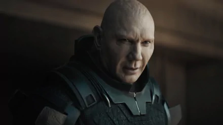 HD wallpaper featuring a character from the 2021 movie Dune, dressed in a futuristic military uniform, with a focused and intense expression.