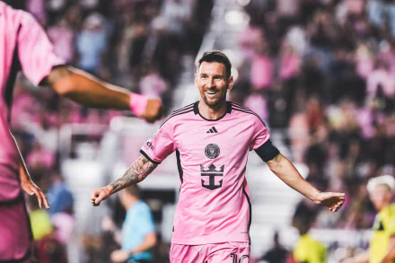HD wallpaper featuring a player in Inter Miami CF pink kit on a soccer field, evoking the dynamic energy of the sport.