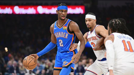 Shai Gilgeous-Alexander of the Oklahoma City Thunder dribbles the basketball during an intense game, captured in this dynamic HD desktop wallpaper.