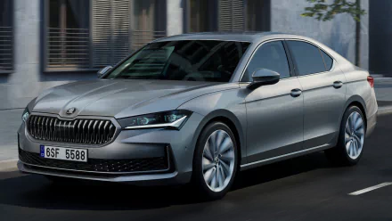 Silver Škoda Superb car HD wallpaper with clean modern design parked on an urban street.