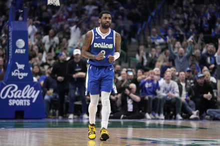 HD desktop wallpaper featuring a Dallas Mavericks basketball player on the court during a game, wearing a blue jersey with the team name and yellow sneakers. Fans are visible in the background.