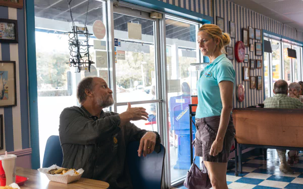 HD desktop wallpaper featuring a scene from the movie Suncoast (2024) with two characters in a diner.