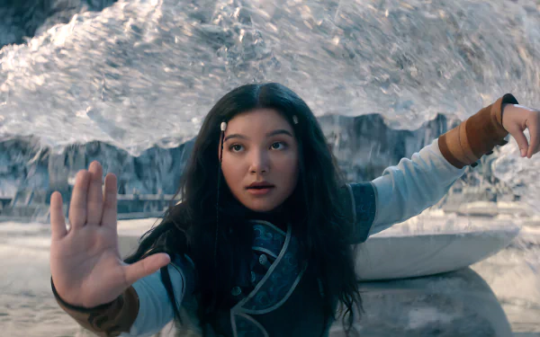 Katara from Avatar: The Last Airbender uses her waterbending skills, creating a powerful wave as she channels her abilities in this vibrant HD wallpaper.