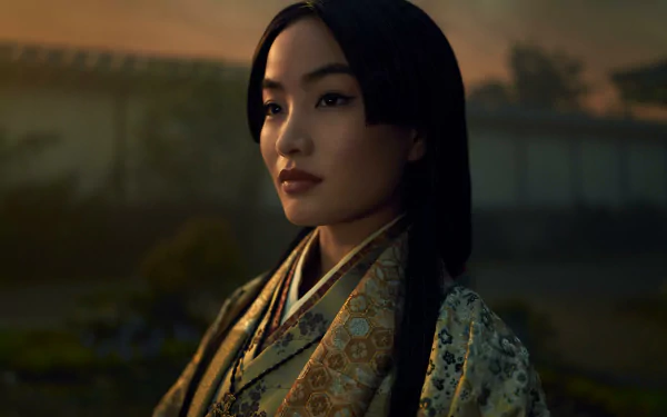 HD desktop wallpaper featuring a character from Shogun (2024) TV show, adorned in traditional attire with a serene expression and a dusk backdrop.