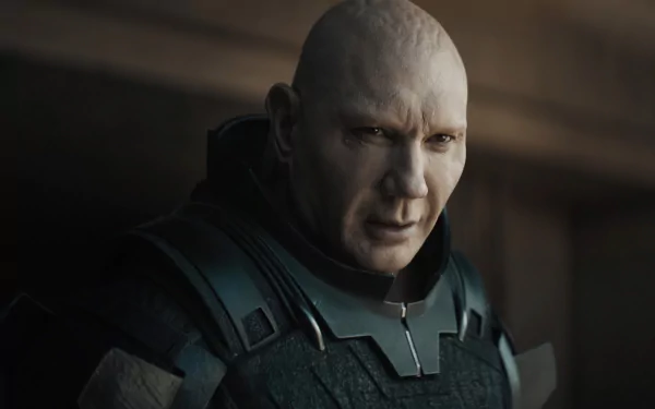 HD wallpaper featuring a character from the 2021 movie Dune, dressed in a futuristic military uniform, with a focused and intense expression.