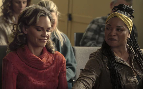 HD Wallpaper of 'Ordinary Angels' featuring two women, one with a turtleneck sweater and the other with a headscarf, giving the impression of a heartfelt moment from the movie.