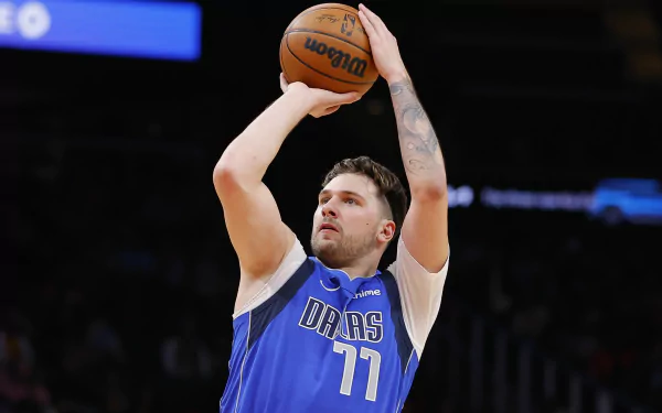 Dallas Mavericks player in blue jersey shooting basketball - HD NBA wallpaper.