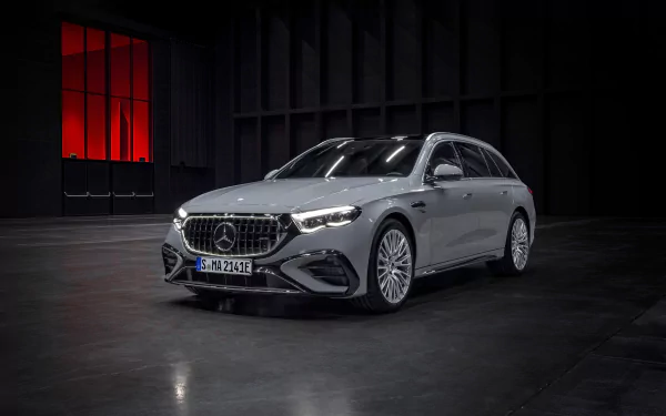 Mercedes-AMG E53 Hybrid car displayed as a HD desktop wallpaper in a dark showroom setting.