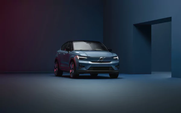 Volvo C40 car showcased as a stylish HD desktop wallpaper with a dark, artistic background.
